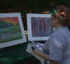 Lady looking at artwork created by students at Mainland High School