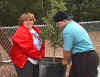 ESE students carring a potted plant to plant at Rose Bay
