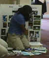 Student Setting Up A Display Board